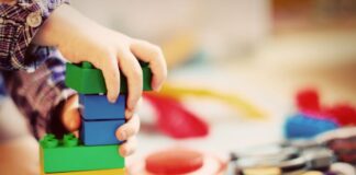 Beginning the Journey of Starting a Daycare Business Outside Your Home child building with Lego blocks in a daycare business