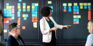 Scheduling Success: Benefits of Critical Path Method in Construction woman teaching others about the critical path method