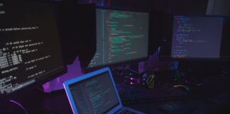 Engineering’s Software Edge: The Case for In-House Development in-house development and a developer's desk with several monitors displaying code