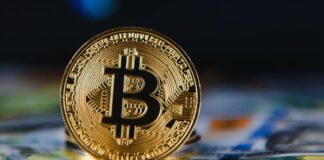 Taking Advantage of Bitcoin: ETF VS. Sole Ownership photo of a gold coin with the Bitcoin logo on it