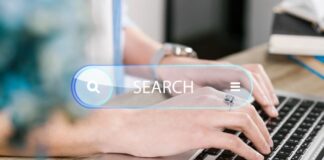 Leveraging Hybrid Cloud Environments for Internal Company Search business woman doing an internal company search on her laptop