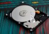 A Guide to Reliable Data Restoration and Recovery Services an uncovered hard drive sitting on a chart representing data restoration