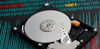 A Guide to Reliable Data Restoration and Recovery Services an uncovered hard drive sitting on a chart representing data restoration