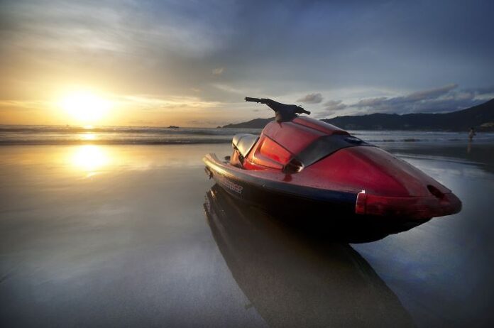red jet ski on a beach in the sunset at a jet ski rental