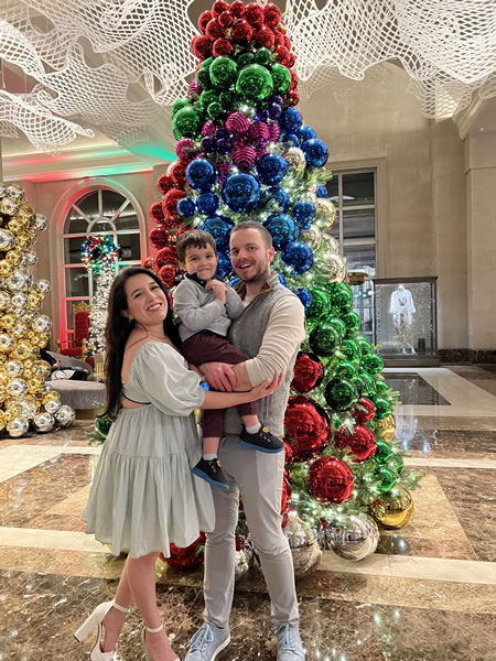 Paul Wnek and his family in front of a Christmas tree