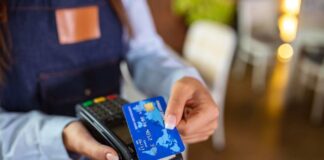 How ISVs Can Exceed Client Needs in the Competitive Payments Industry woman using payment system with a credit card built by ISVs