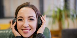 Securing Success: Leveraging Call Recording for Business Growth smiling girl holding her headset to her ears during call recording