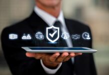 Ensuring Vendor Compliance and Risk Management businessman holding a tablet with digital icons representing compliance and risk management