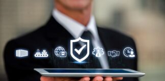 Ensuring Vendor Compliance and Risk Management businessman holding a tablet with digital icons representing compliance and risk management