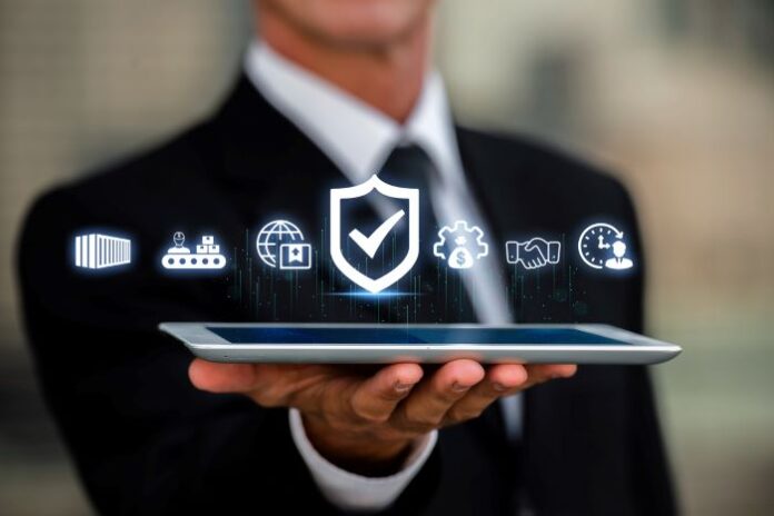 businessman holding a tablet with digital icons representing compliance and risk management