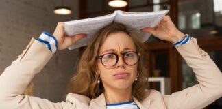 How to Read Faster and Retain More Information? perplexed woman with a book on her head trying to retain more information