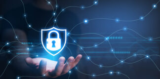 What is a VPN? A Beginner’s Guide in 2024? A hand underneath a lighted lock with lighted wires spreading out from the lock representing a VPN