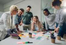 Why Employee Recognition Matters employees around a table receiving employee recognition