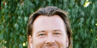 Nick Slettengren Feature Nick Slettengren headshot in black suit