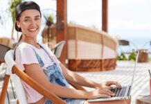 5 Non-Obvious Ways To Stay Safe On Your Upcoming Vacation girl on laptop staying safe during Vacation
