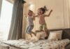 Creating a Kid-Friendly Airbnb: Tips for Attracting Families Happy children jumping on a bed in a kid-friendly Airbnb