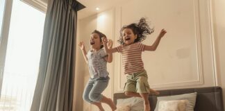 Creating a Kid-Friendly Airbnb: Tips for Attracting Families Happy children jumping on a bed in a kid-friendly Airbnb