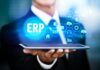 How to Choose the Best ERP System for Your Business Man holding a tablet with ERP System graphic hovering above