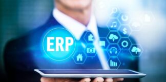 How to Choose the Best ERP System for Your Business Man holding a tablet with ERP System graphic hovering above