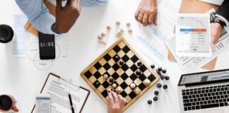 How to Track Competitor Keywords and Improve Your Content Strategy Top view of desk with chessboard, where business owners are using content strategy