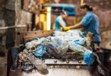 How AI and ML are Shaping the Future of the Recycling Industry Two workers in the recycling industry sorting recyclables