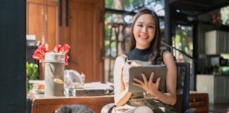 Tips To Help You Thrive as a Small Business Owner A small business owner working on her business sitting at a cafe with a cat