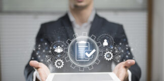 Surprising Ways Software Integrations Can Improve Business Operations Man holding a laptop computer while running software integraitons