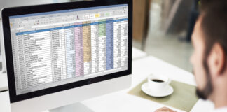 Why Converting Excel to PDF Can Save Your Business Time and Money Manager on his desktop computer converting Excel to a PDF