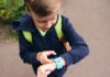 Tech on the Move: How Wearable Gadgets Encourage Kids to Stay Active Boy using wearable gadget to track fitness