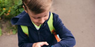 Tech on the Move: How Wearable Gadgets Encourage Kids to Stay Active Boy using wearable gadget to track fitness