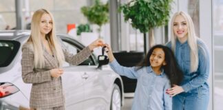 Buying a Tesla – What You Need to Know A woman and girl buying a Tesla from a saleslady