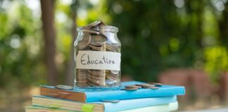 How to Use Tech to Lower Your College CostsĀ 4 used school notebooks with a jar on top with coins that says "education," to show college costs