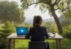 Optimizing Cybersecurity in a Remote Work Environment A remote worker outside at a desk, optimizing cybersecurity