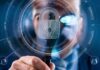 Understanding Identity Verification Solutions: A Comprehensive Guide view through a magnifying glass of a person, with a lock graphic, showing identification verification