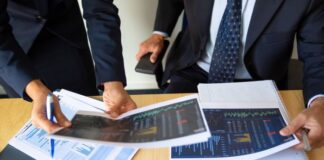 How to Enhance Your Asset Management Using Crypto Managers around a desk tracking their asset management