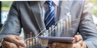 How To Keep Your Business Finances Healthy For 2024 And Beyond man on tablet keeping his business finances healthy