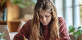 Managing Project Deadlines and Homework Across Multiple College Courses college girl working on her homework at her desk