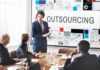Boost Productivity and Growth by Outsourcing These Business Functions businessman presenting to his colleagues about outsourcing business functions