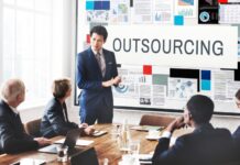 Boost Your Business Growth with Specialized Outsourcing Services Business team strategizing about specialized outsourcing