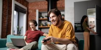 Key Features for a Seamless Tech Experience in Your New Place  Roommates in their new home enjoying a seamless tech experience