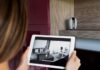 Why Cloud Cameras are Revolutionizing Home Security Woman holding tablet showing cloud camera home security