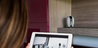 Why Cloud Cameras are Revolutionizing Home Security Woman holding tablet showing cloud camera home security