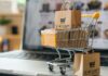 How To Maintain Balance Between Costs and Earned Profit in E-commerce small cart with boxes on laptop to show how to maintain balance with costs and profit