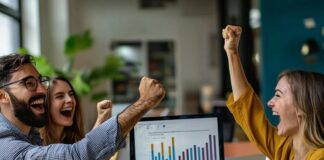Understanding Marketing Attribution Models for Success Work team cheering because they used marketing attribution models