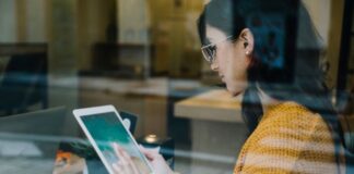 The Role of Technology in Modern Franchise Management woman on a tablet working with her franchise management platform