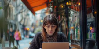 How Tech is Making Online Business Degrees More Accessible & Affordable Woman looking at business degrees online at a cafe