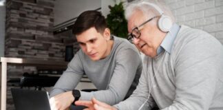 Why I Left Wall Street to Seize the $38 Trillion Longevity Opportunity senior citizen and a younger man helping him navigate the electronic healthcare space for longevity