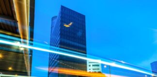 Key Leadership Skills for Thriving in Today’s Dynamic Business Landscape Light trails on road by business buildings, to illustrate leadership skills