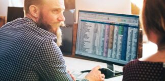 How Amazon Repricer Software Improves Profit Margins business owner using repricer software on his desktop computer