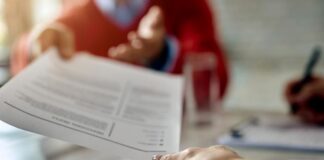 Creating a Career-Switcher Resume: How AI Tools Can Showcase Transferable Skills job applicant giving resume with transferable skills to manager